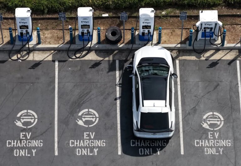 Factors Driving the Increase in Used Electric Vehicle Sales Beyond Gas Prices A row of electric vehicles plugged into public charging stations in a parking lot